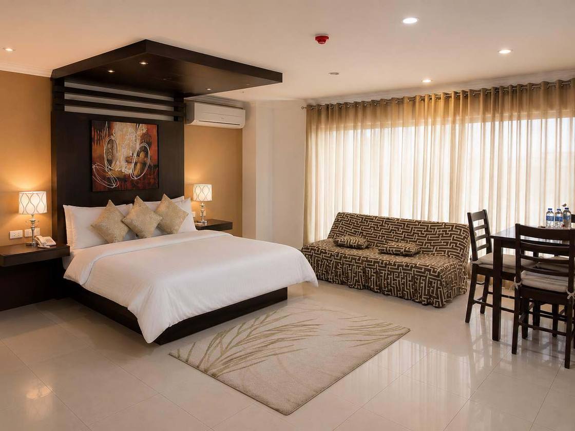 Spacious guest room with king bed and sofa seating